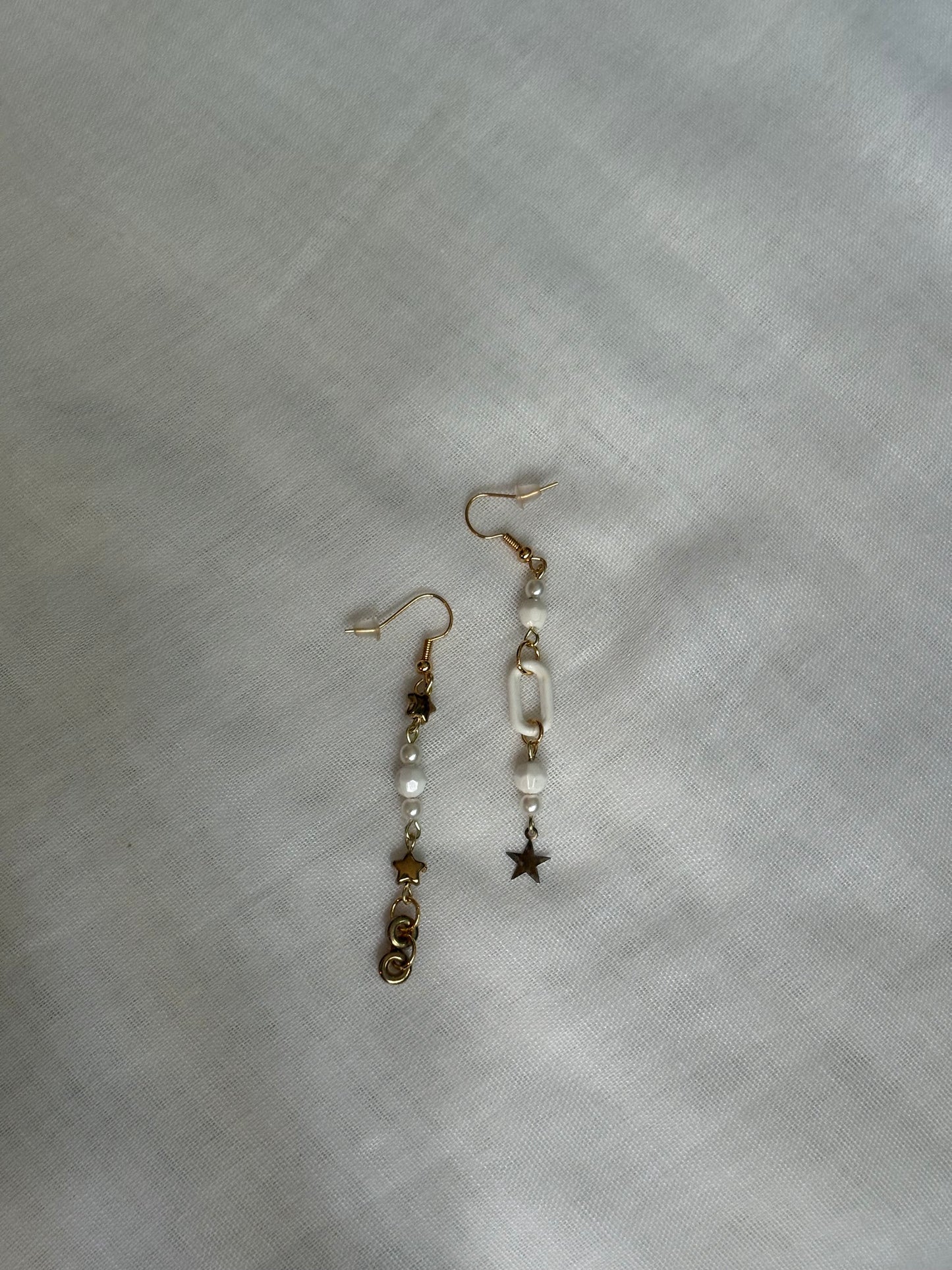 Asymmetric White Earrings with Gold Star Details